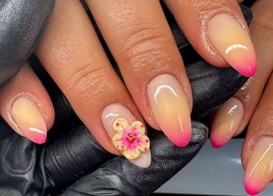 Stunning pink ombre nails with floral design at Lani Nails London, London, GB.