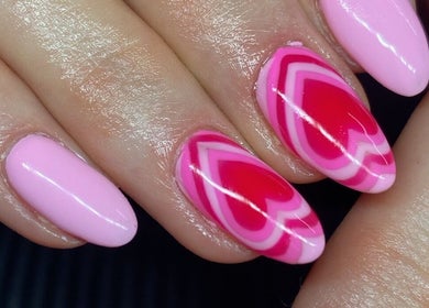 Close-up of heart-themed pink nail art at Lani Nails London, GB.