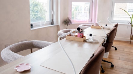 Modern manicure station at Lani Nails London, featuring cozy chairs and bright decor. Located in London, GB.