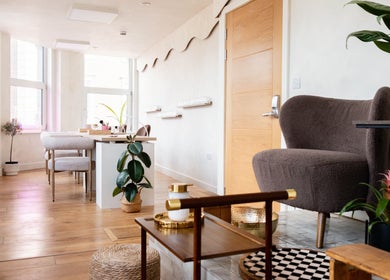 Modern, elegant interior of Lani Nails London, featuring plush seating and natural decor. Located in London, GB.