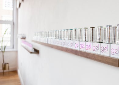 Shelf of gel nail polishes at Lani Nails London, elegant display in sunny London, GB salon.