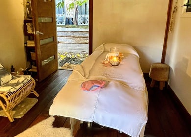 Lil’Ohana Massage - Mini Tropical Escape treatment room, Southport, Queensland, AU with plush chair and massage table.