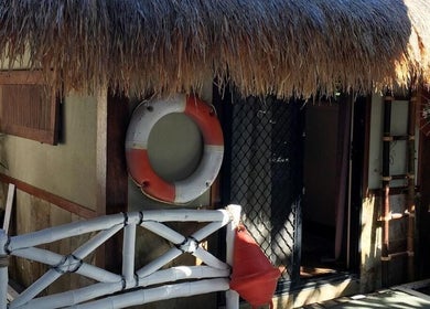 Lil’Ohana Massage - Mini Tropical Escape entrance in Southport, Queensland, AU with rustic island decor.