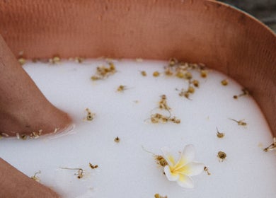 Foot soak at Lil’Ohana Massage - Mini Tropical Escape, Southport, Queensland, AU with floral petals.