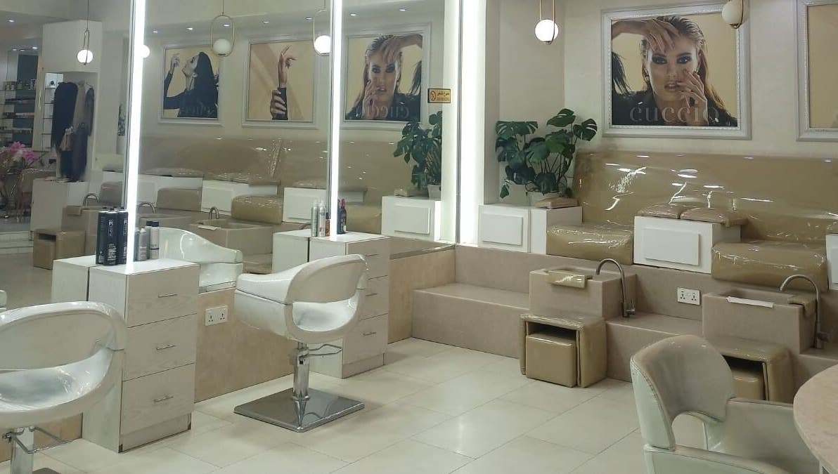 Spacious interior of House of Nails, Dubai, featuring luxurious nail stations for an elegant beauty experience.