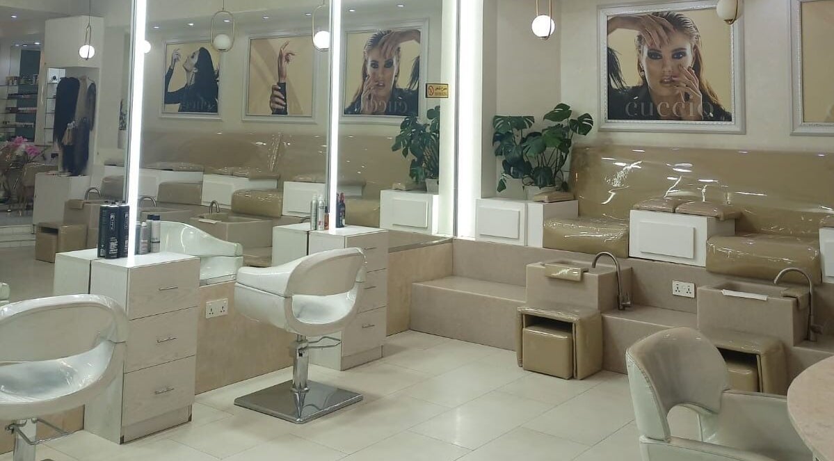 Spacious interior of House of Nails, Dubai, featuring luxurious nail stations for an elegant beauty experience.