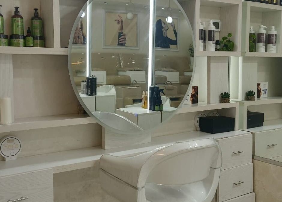 Modern salon setup at House of Nails, Dubai Fairmont, AE, featuring chic mirror and beauty products.