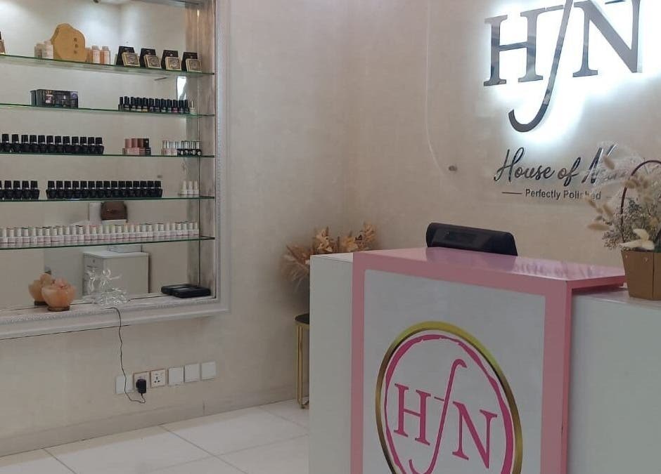 Reception area of House of Nails, Dubai Fairmont, AE, showcasing stylish decor and nail products.