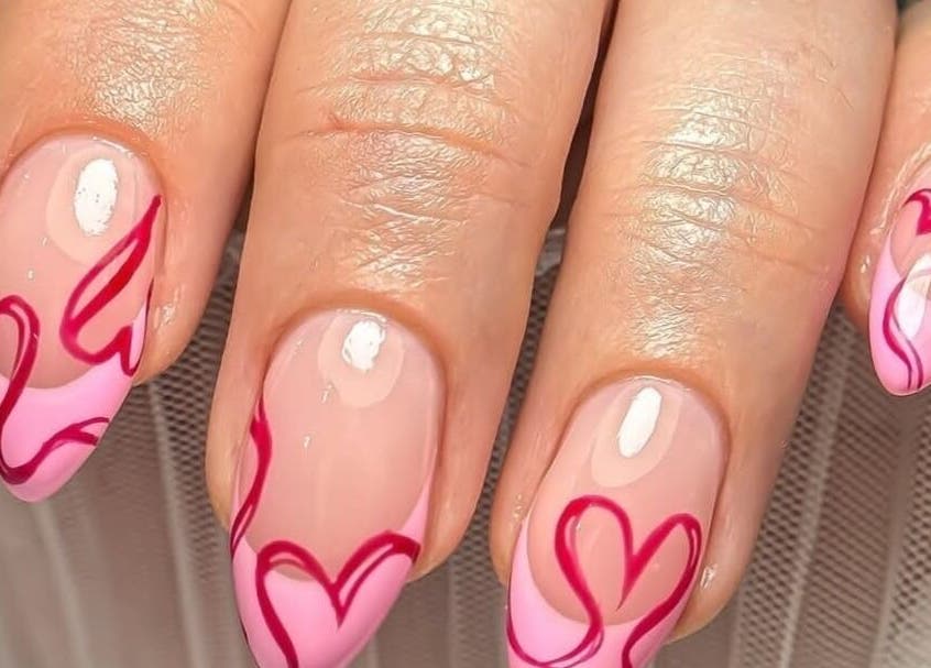 Heart-themed nail art from House of Nails, Dubai Fairmont, AE showcasing pink and red designs.