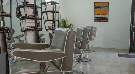 Chic interior of STUDIO26 Barbershop featuring modern chairs in Hazel Grove, England, GB.