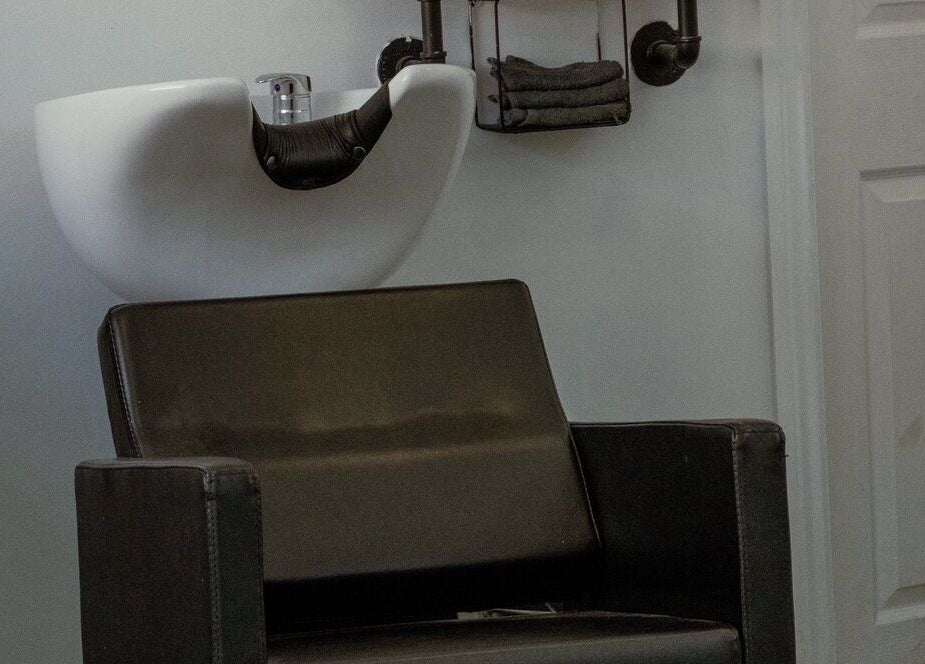 Modern salon chair and sink at STUDIO26 Barbershop, Hazel Grove, England, GB.