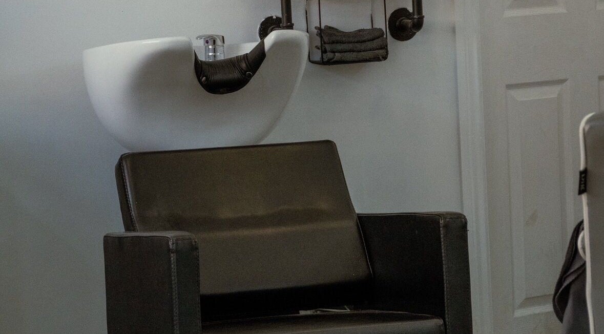 Modern salon chair and sink at STUDIO26 Barbershop, Hazel Grove, England, GB.