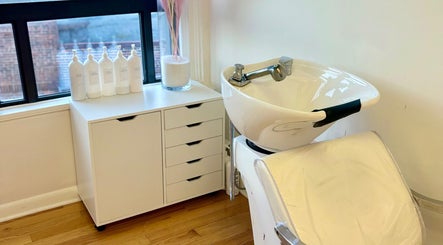 Modern shampoo station at Dream Salon in Brookline, Massachusetts, US, showcasing sleek design and comfort.