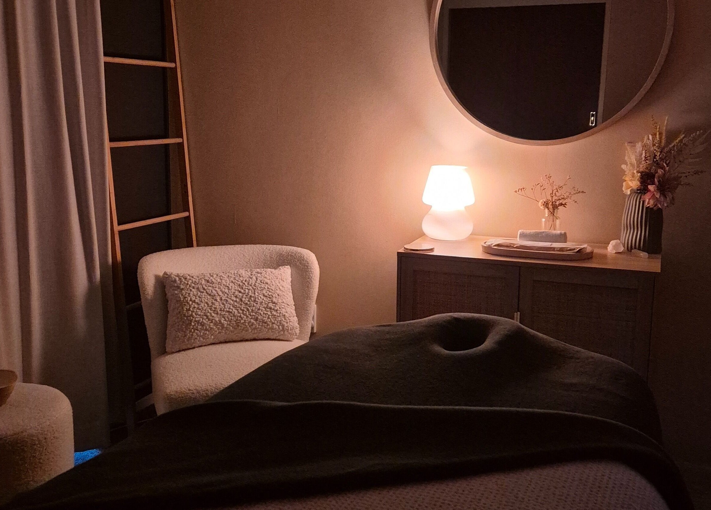 Cozy spa room at Haven For Self in Hamilton, Waikato, NZ, featuring ambient lighting and elegant decor.
