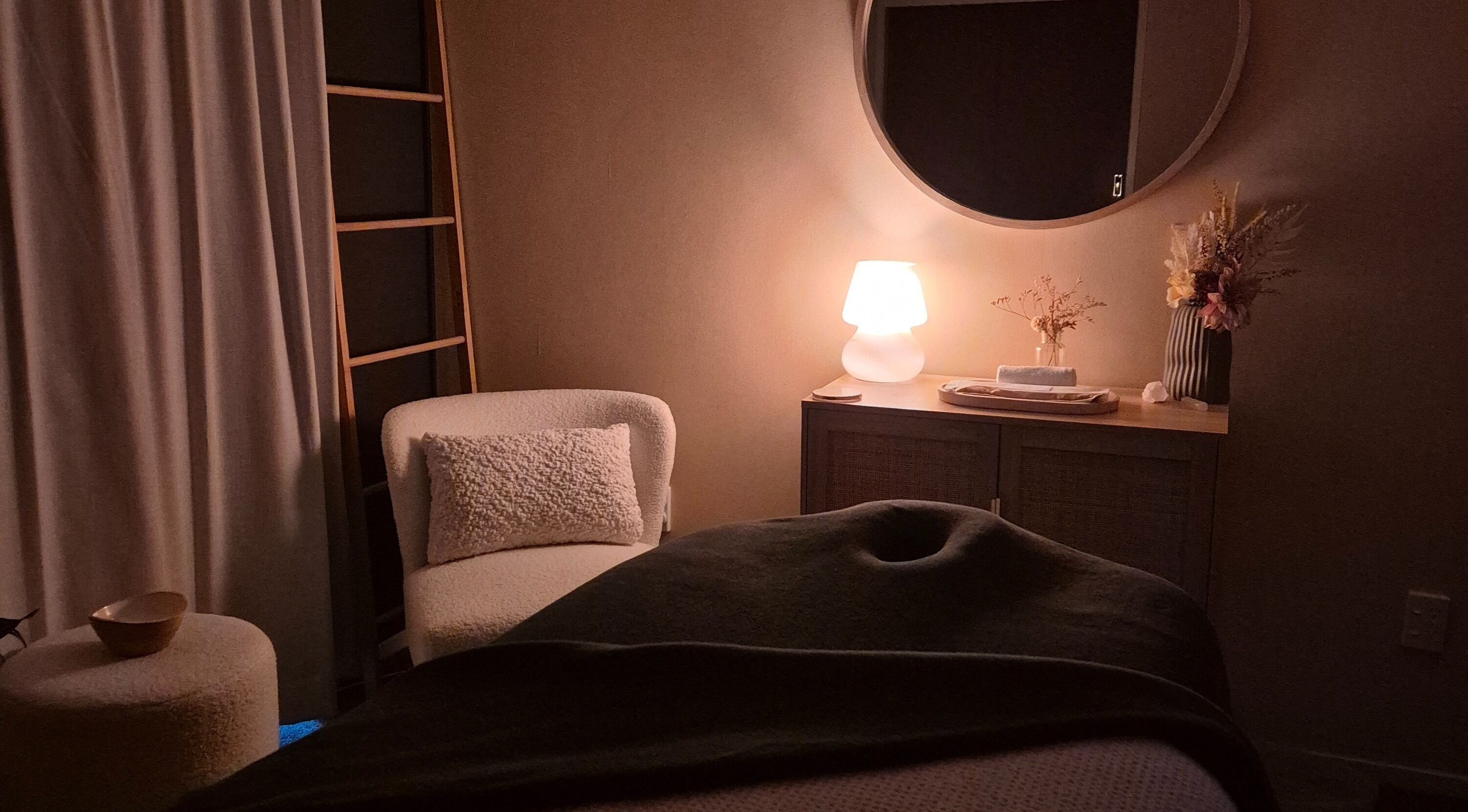 Cozy spa room at Haven For Self in Hamilton, Waikato, NZ, featuring ambient lighting and elegant decor.