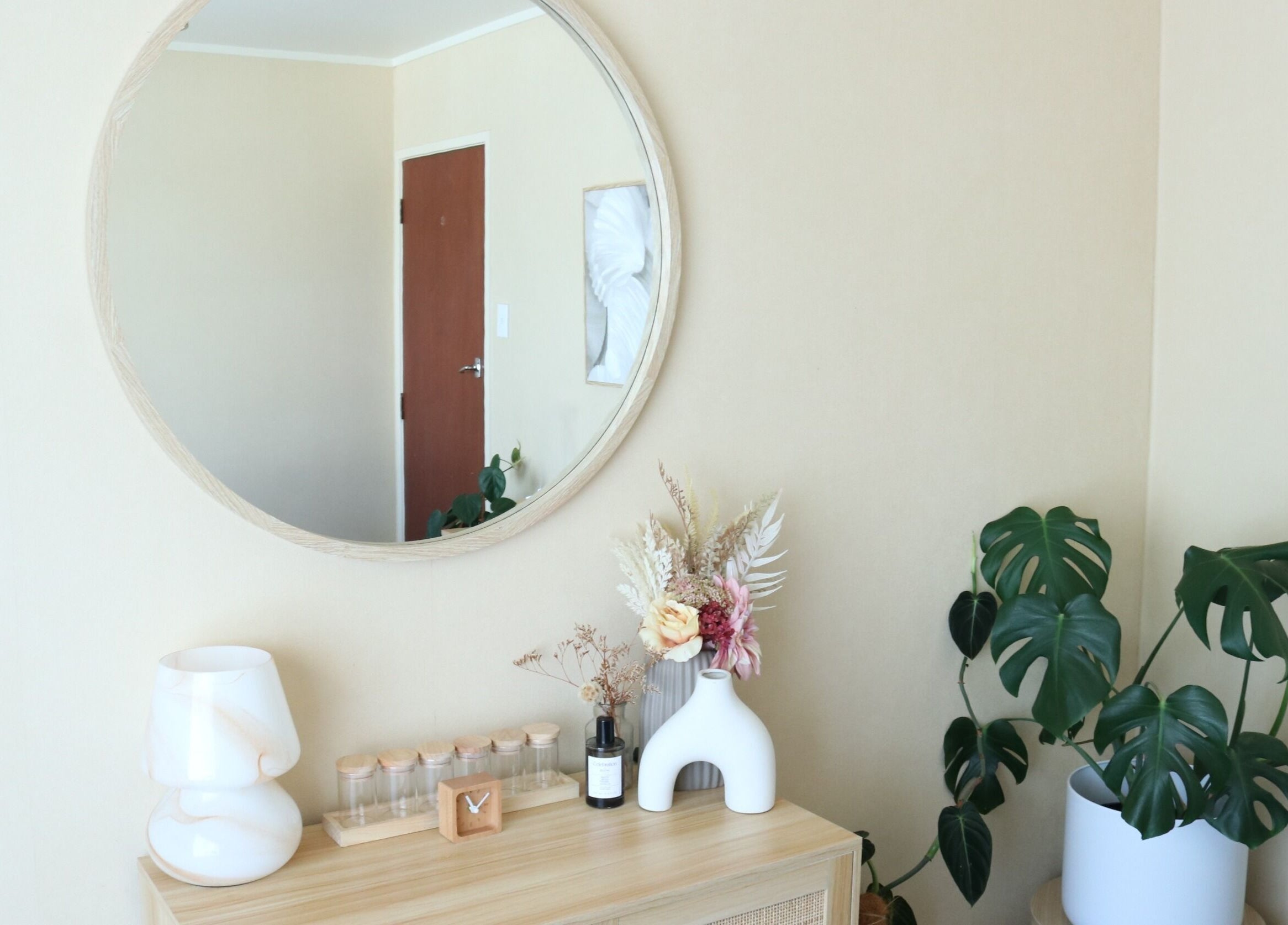 Elegant decor at Haven For Self, Hamilton, Waikato, NZ with mirror, plants, and ceramics creating a serene ambiance.