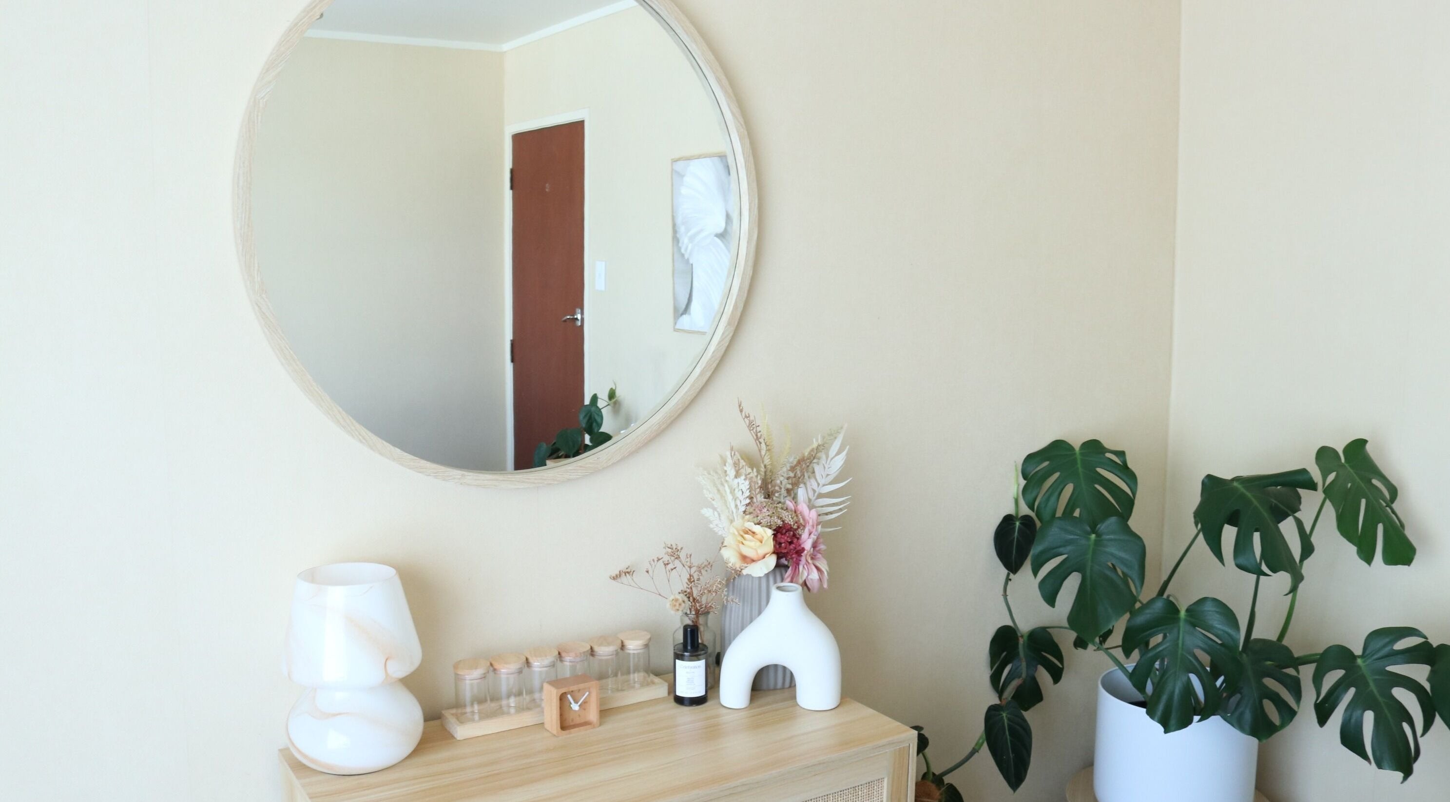 Elegant decor at Haven For Self, Hamilton, Waikato, NZ with mirror, plants, and ceramics creating a serene ambiance.
