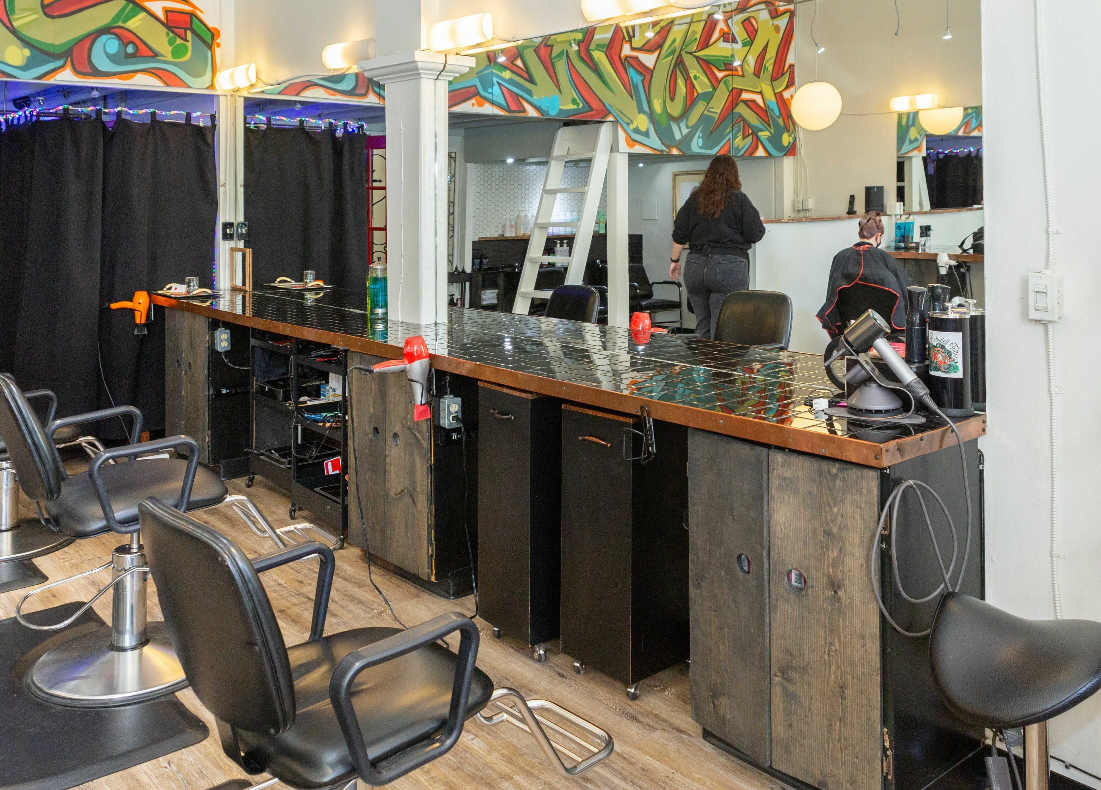 Interior of Colourbox salon in Vancouver, British Columbia, CA with colorful decor and modern styling chairs.