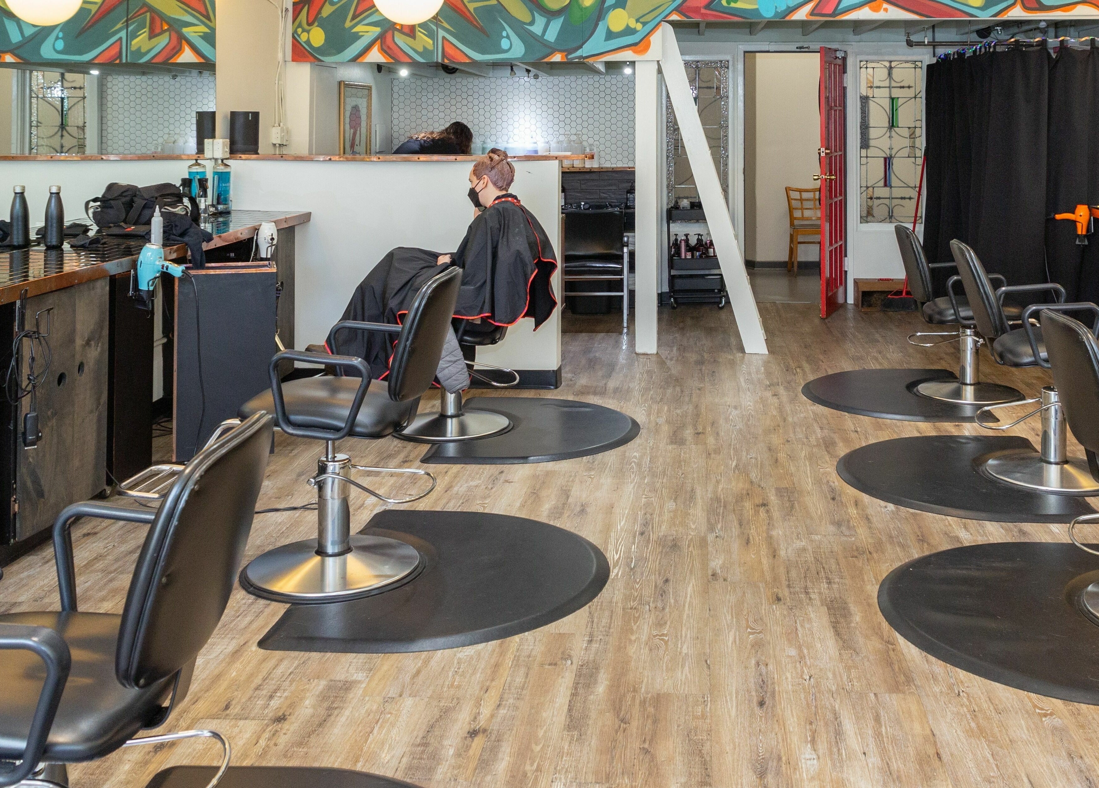 Modern salon interior at Colourbox in Vancouver, British Columbia, CA with chairs and vibrant decor.