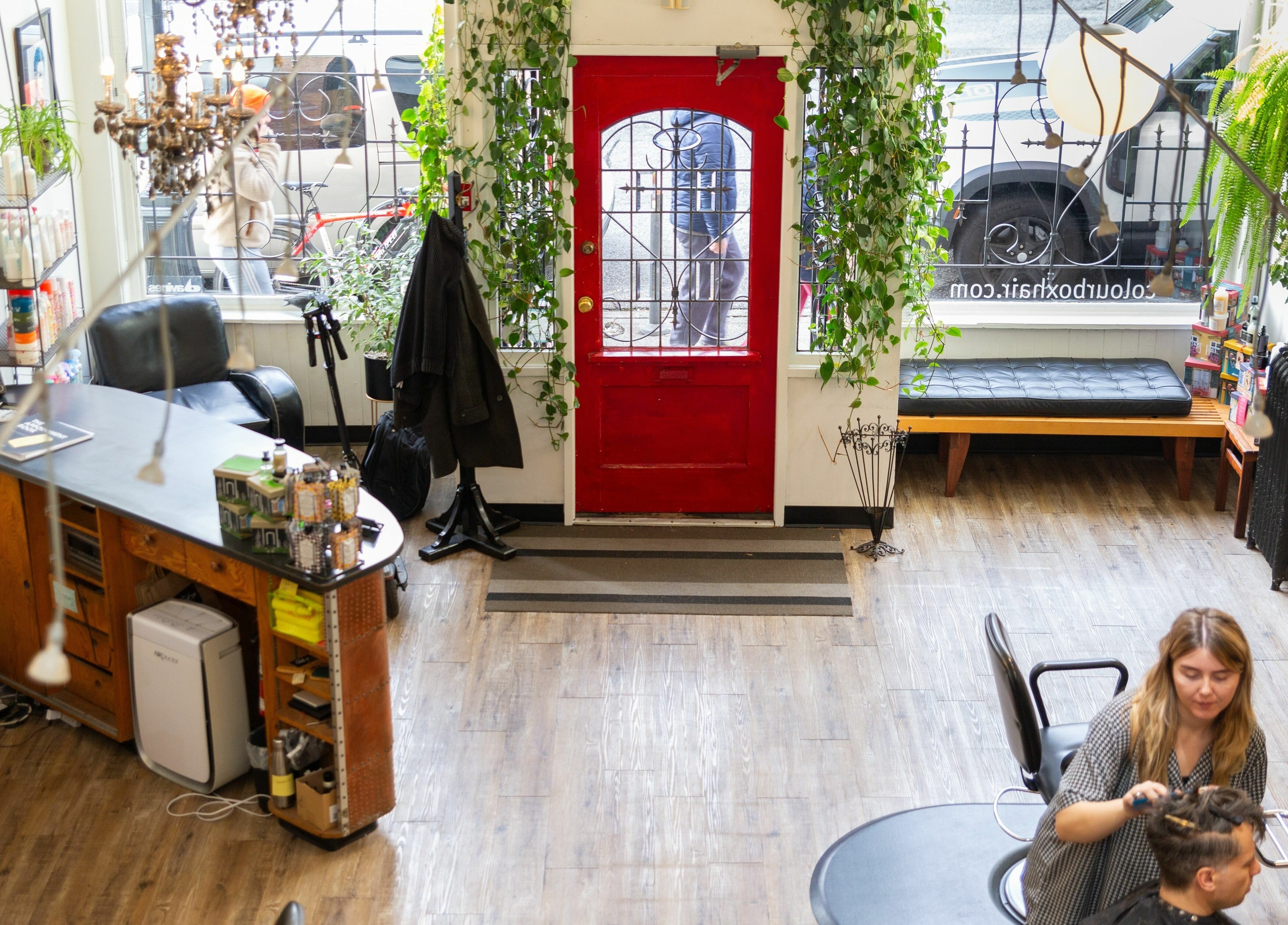 Inside Colourbox salon in Vancouver, BC featuring stylish decor and hair service in action.