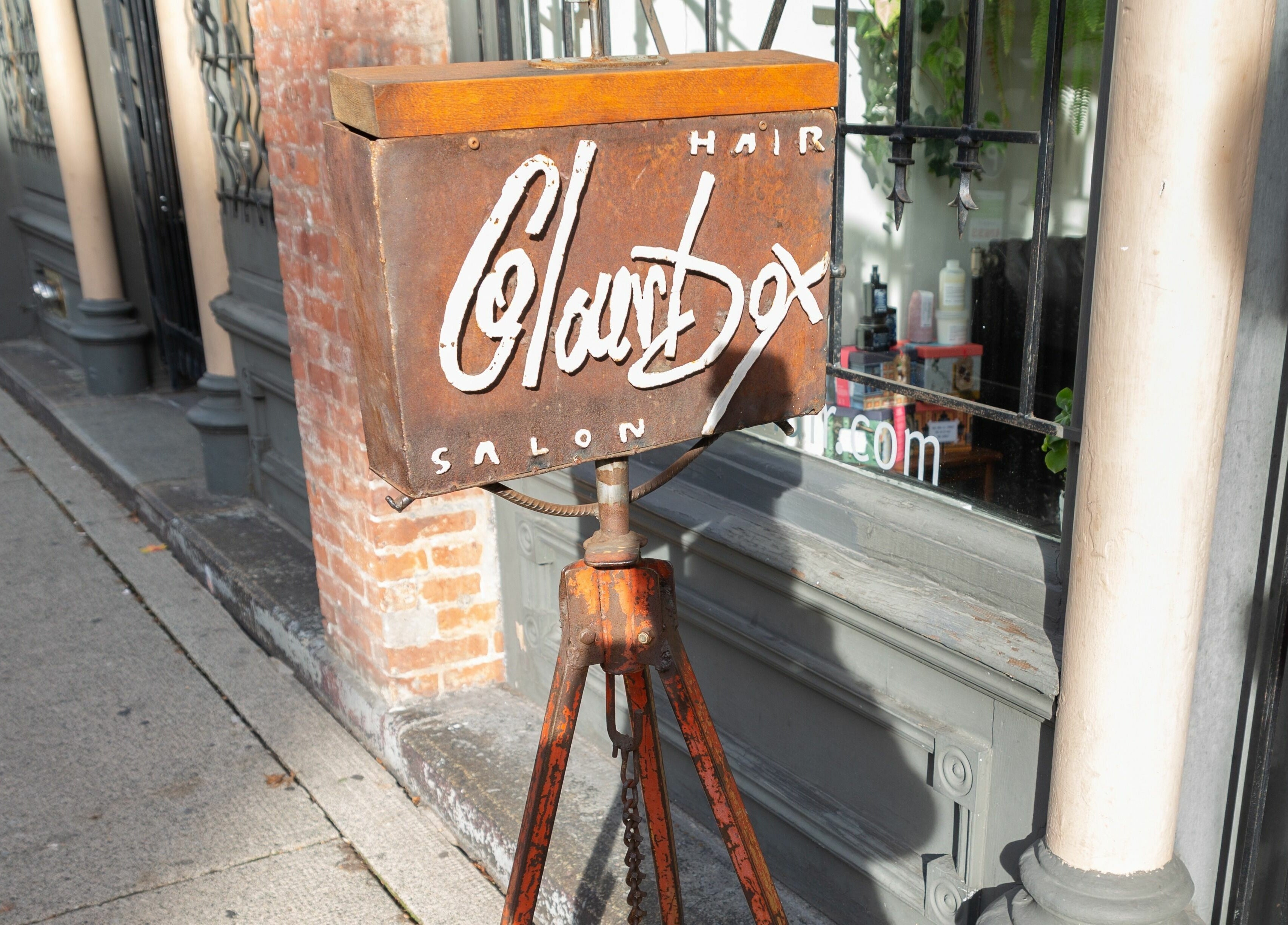 Rustic sign outside Colourbox salon in Vancouver, British Columbia, CA, showcasing its inviting entrance.