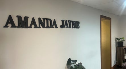Amanda Jayne Hairdressing entrance sign in Swalwell, England, GB with decorative plants.