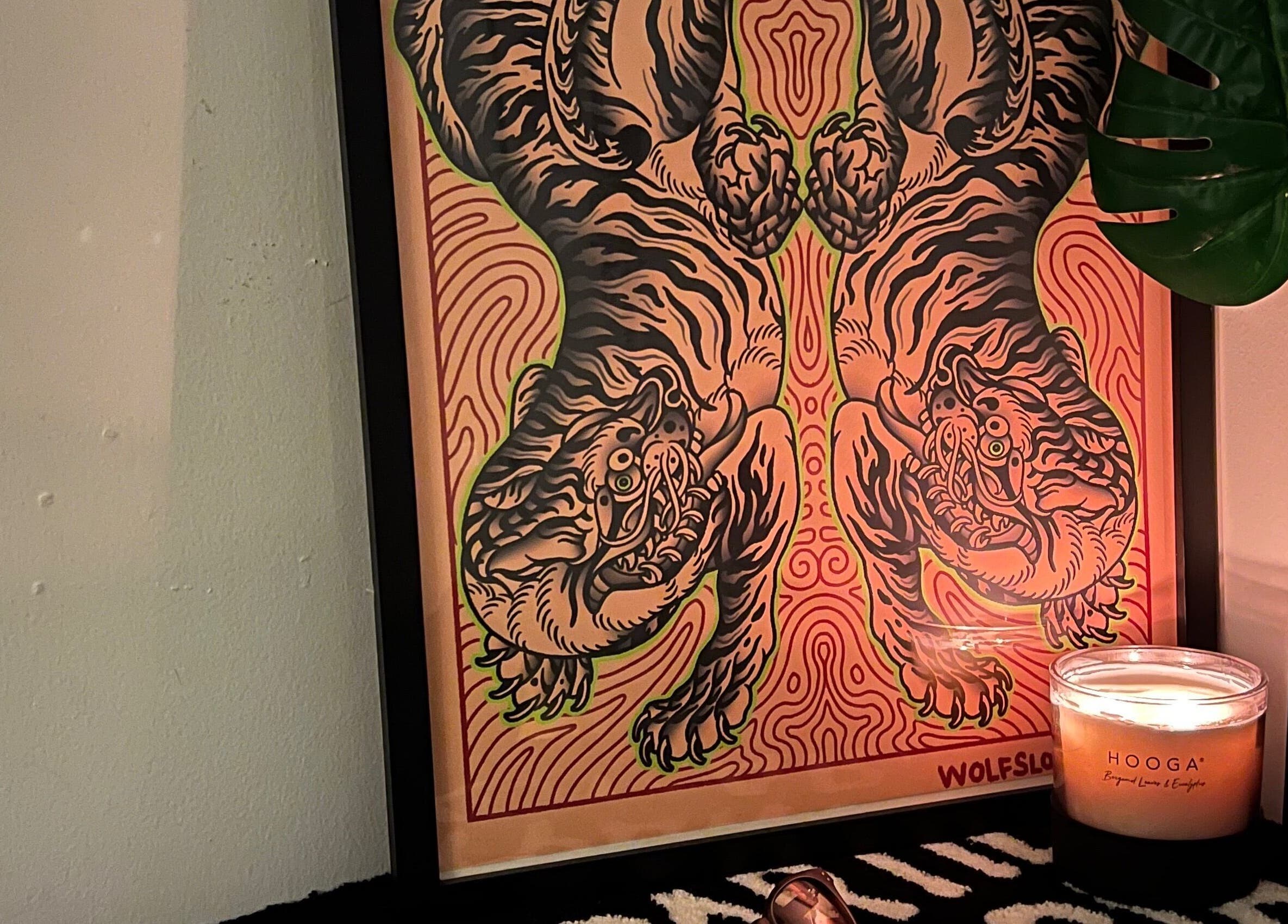 Tiger art poster with lit candle at Tōji, Singapore, SG. Creates a calm and relaxing atmosphere.