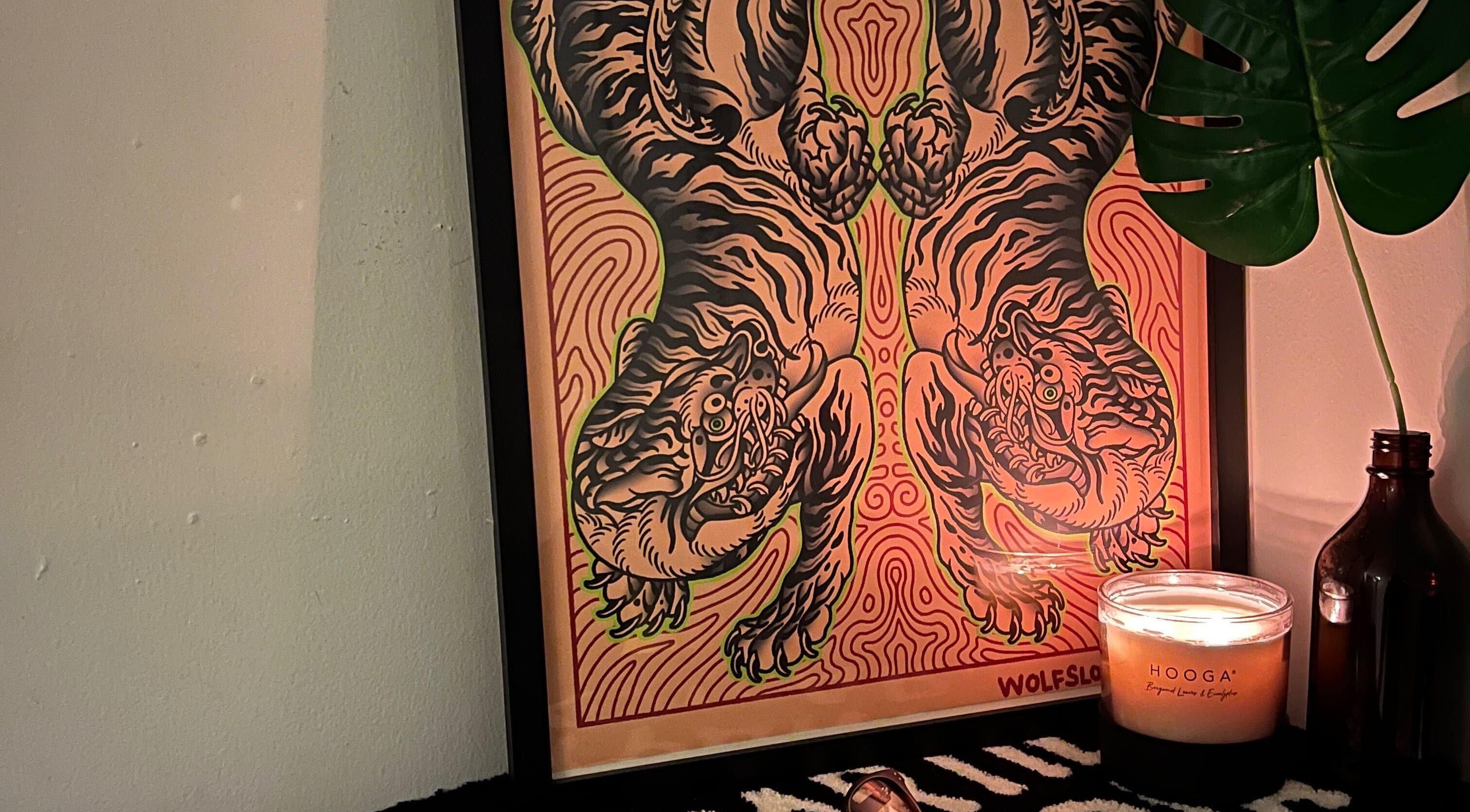Tiger art poster with lit candle at Tōji, Singapore, SG. Creates a calm and relaxing atmosphere.