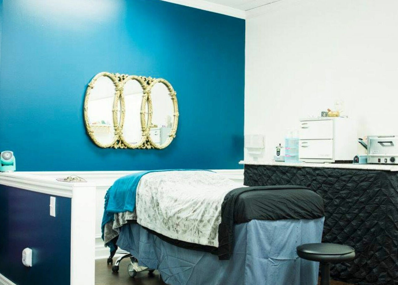 Tranquil treatment room at Spa Liz and Co. in Greenfield, Wisconsin, US with elegant decor and plush bedding.