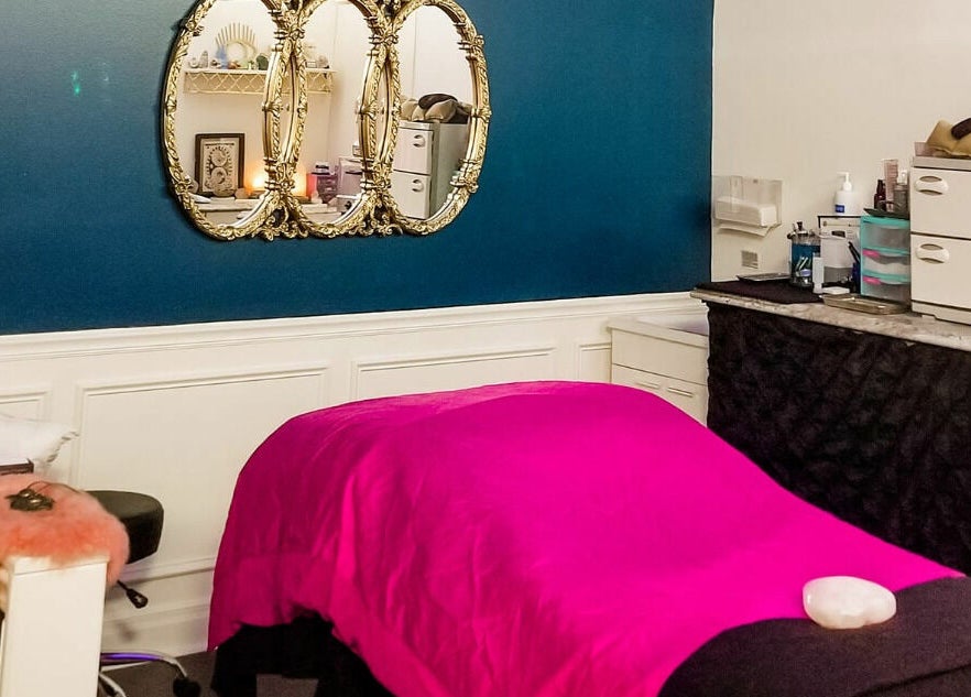 Luxurious spa room at Spa Liz and Co., Greenfield, Wisconsin, US with vibrant decor and massage table.