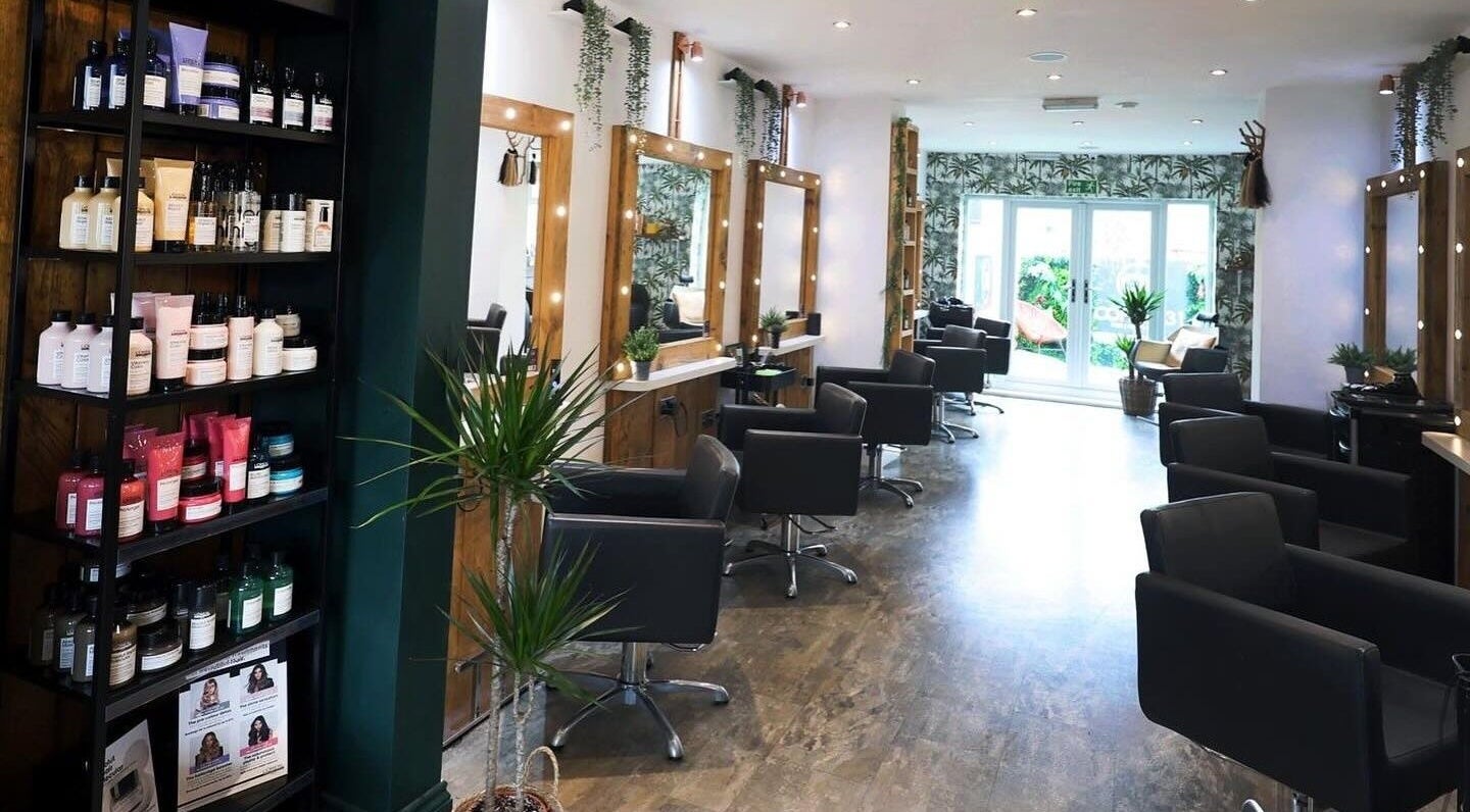 Modern salon interior at Ellen Ormesher Hair in Rainford, England, GB, featuring stylish chairs and mirrors.