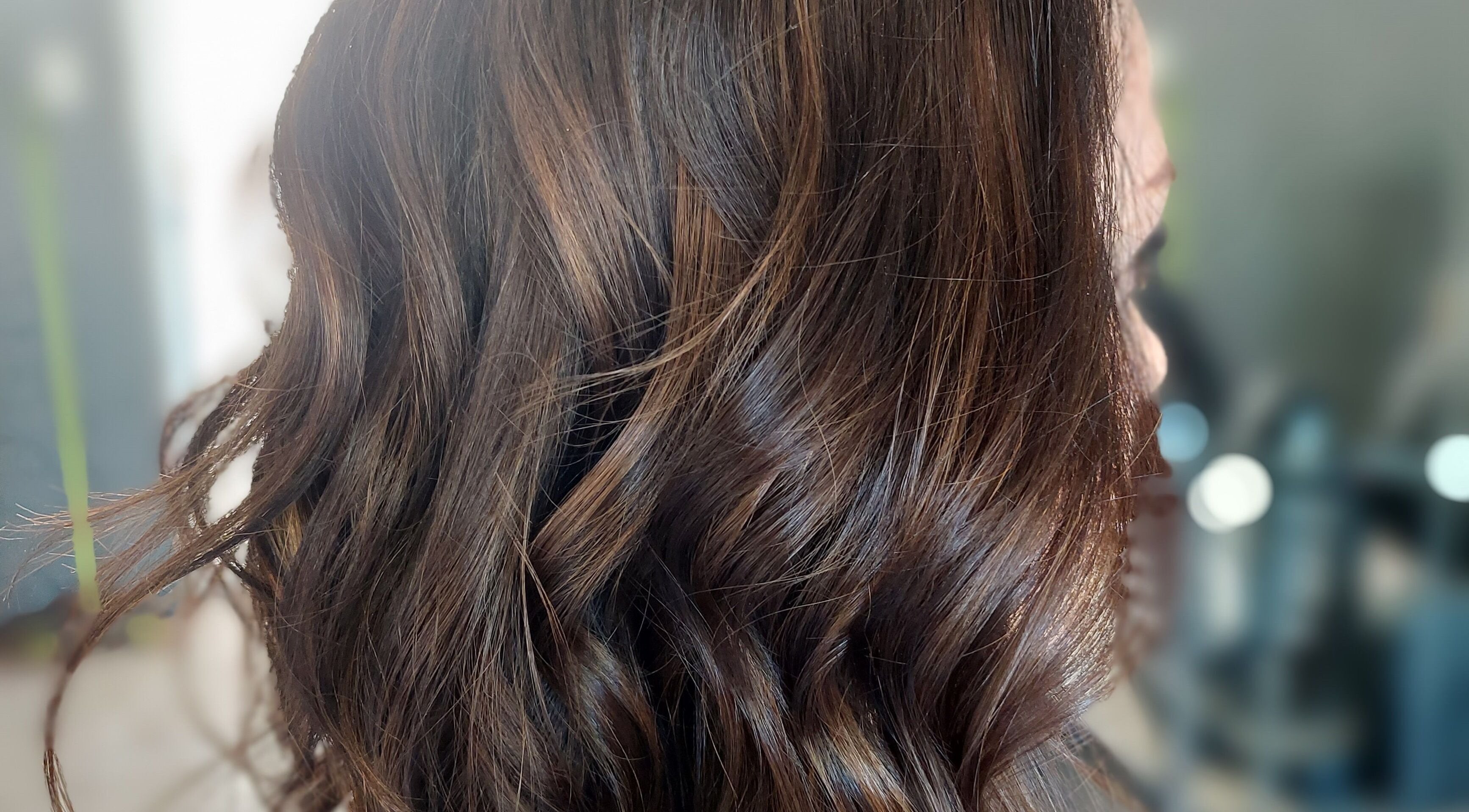 Rich, wavy brown hair styled at Beyond the Chair, Pretoria, Gauteng, ZA in a sleek, professional look.