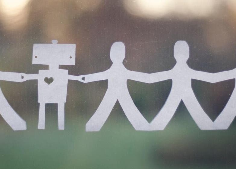 Paper figures holding hands symbolizing community at Beyond the Chair, Pretoria, Gauteng, ZA.