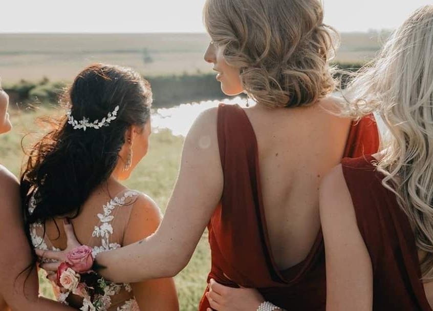 Bridesmaids in elegant gowns support the bride at Beyond the Chair, Pretoria, Gauteng, ZA.