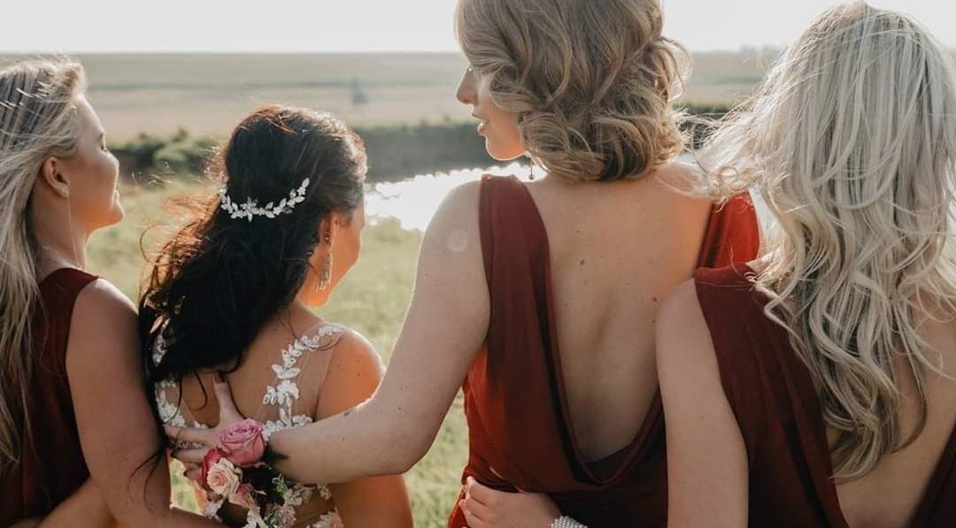 Bridesmaids in elegant gowns support the bride at Beyond the Chair, Pretoria, Gauteng, ZA.