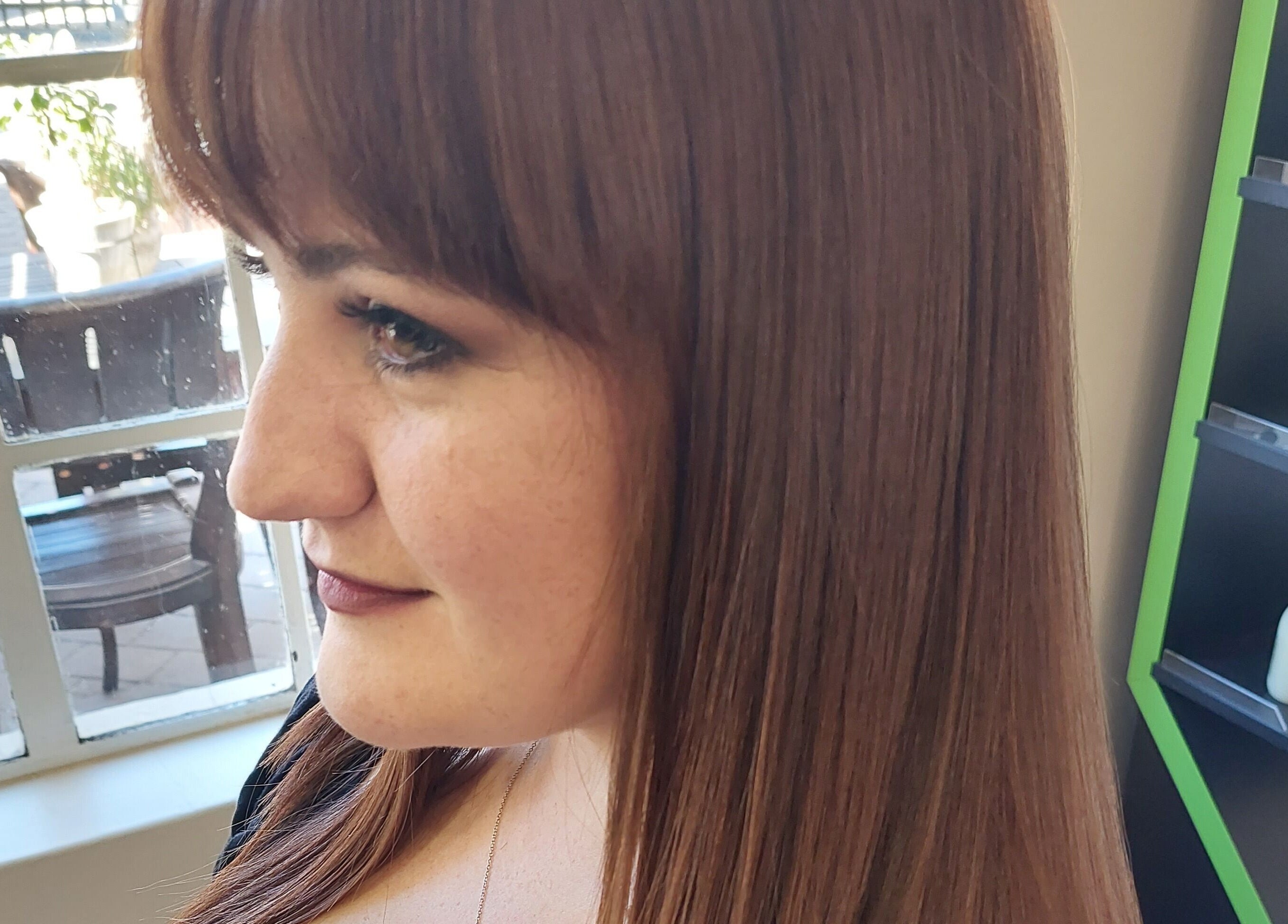 Woman with sleek hair at Beyond the Chair, Pretoria, Gauteng, ZA, enjoying a luxurious salon experience.