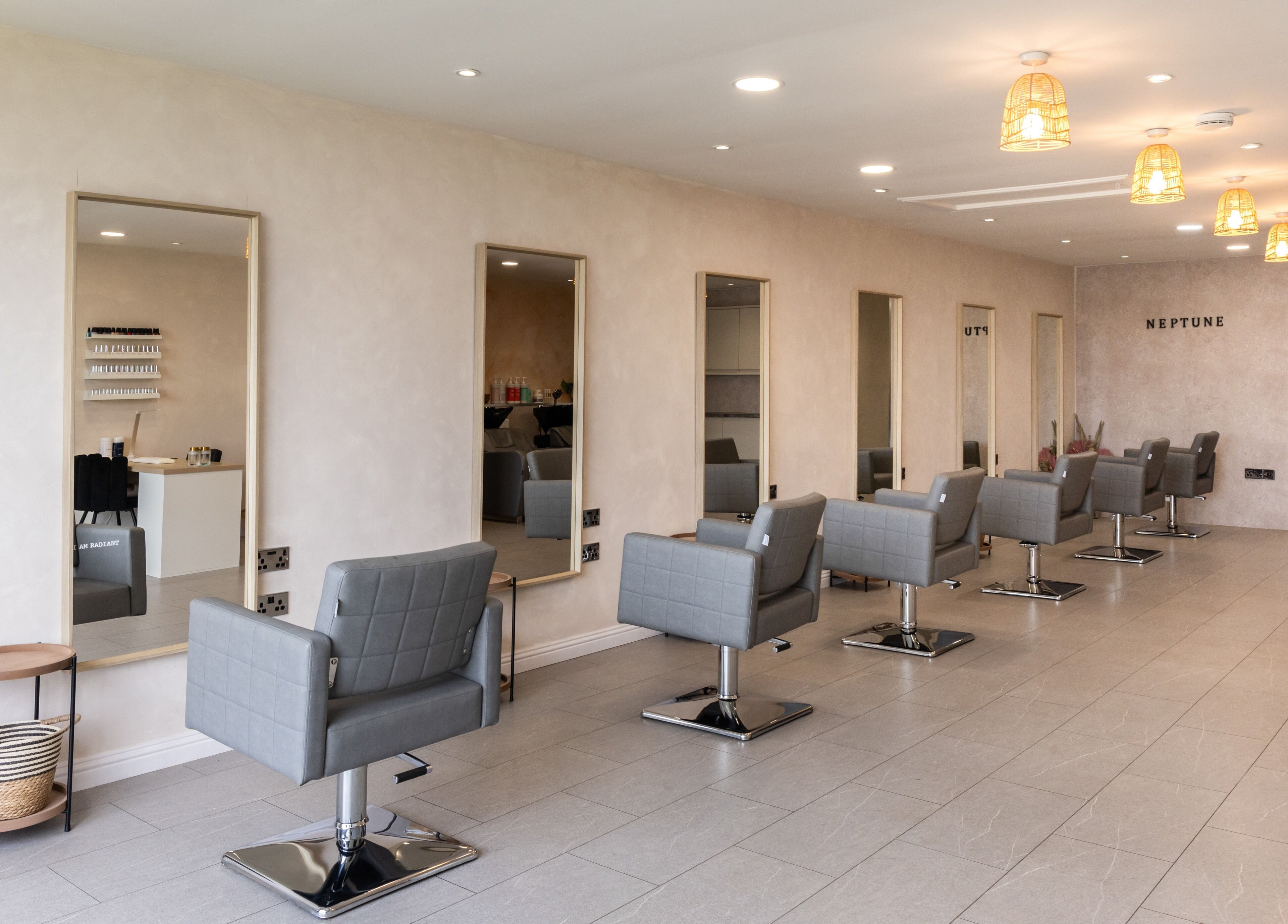 Stylish salon interior at Neptune, Livingston, Scotland, GB with grey chairs and modern decor.