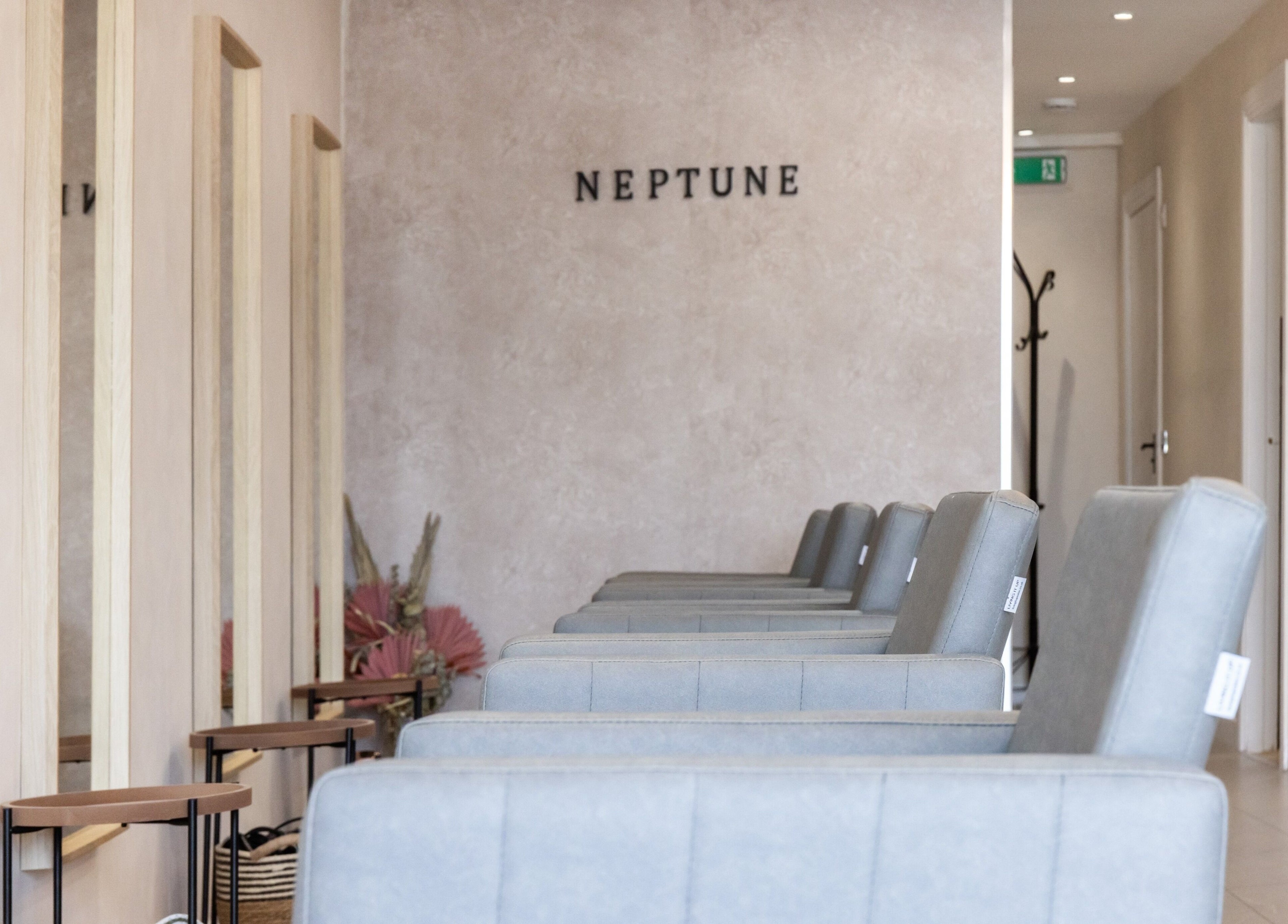 Stylish salon interior of Neptune in Livingston, Scotland, GB with modern seating and minimalist decor.