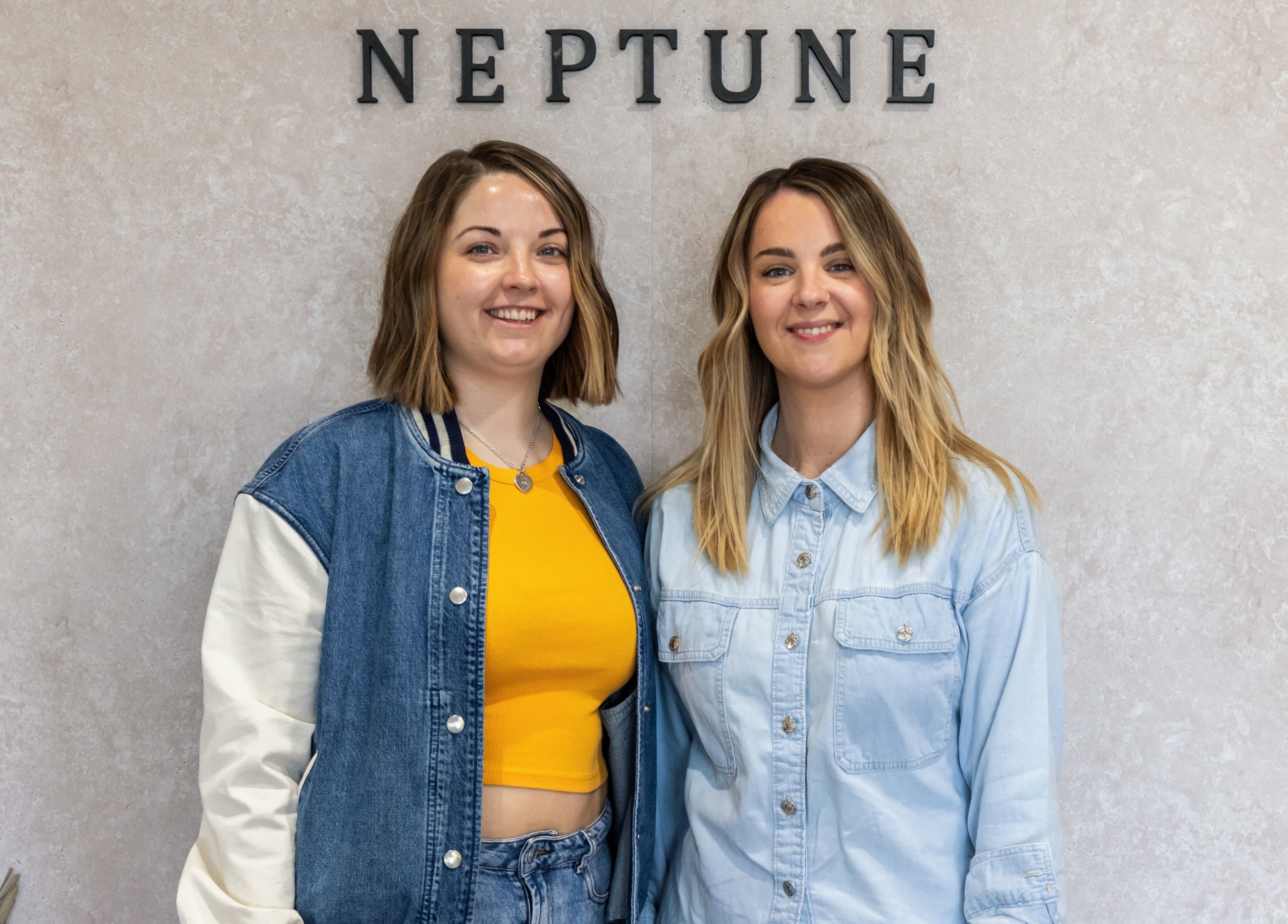 Team members smiling at Neptune, Livingston, Scotland, GB, promoting welcoming atmosphere.