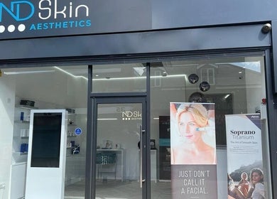 Front entrance of ND Skin Aesthetics, Leicester, England, GB showcasing modern design and promotional banners.