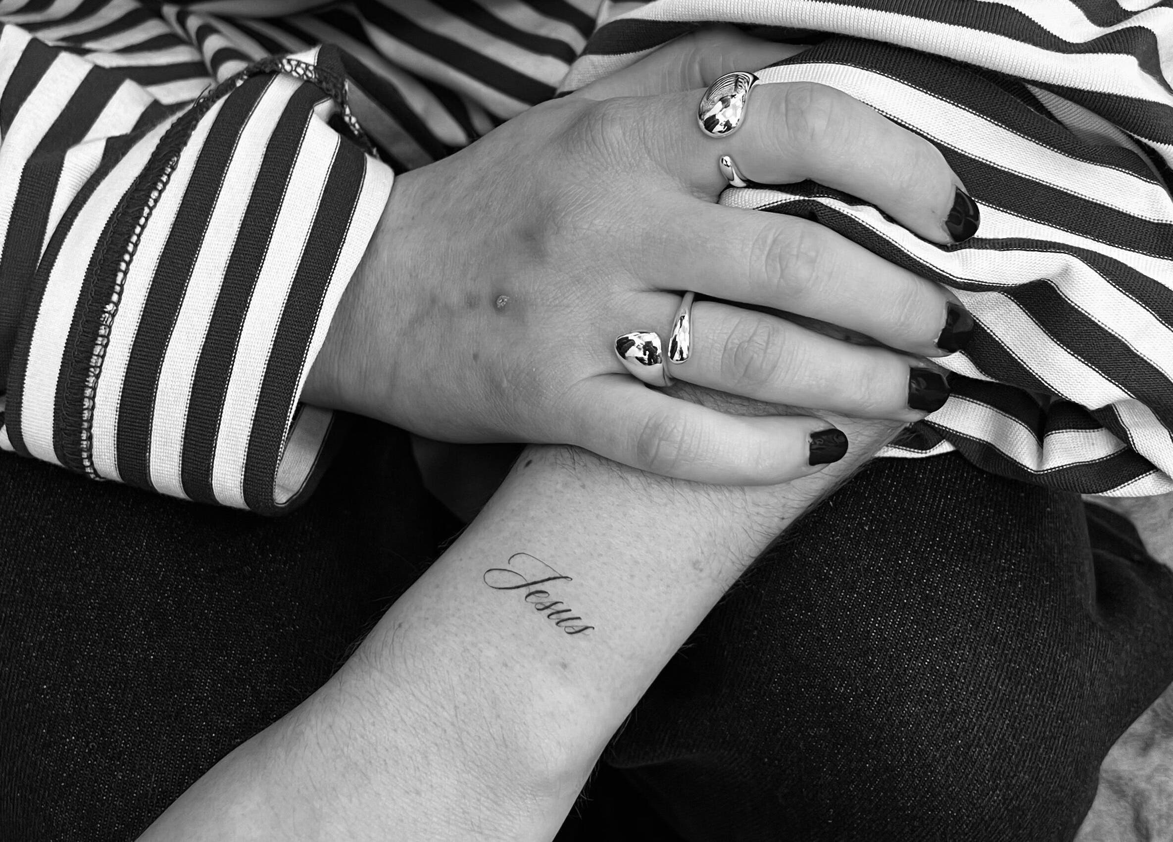 Close-up of a tattooed arm with 'Jesus' at Tri Line Tattoos, Auckland, Auckland, NZ.