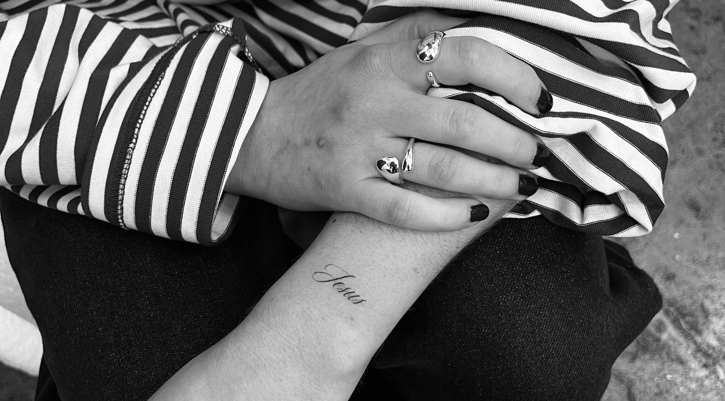 Close-up of a tattooed arm with 'Jesus' at Tri Line Tattoos, Auckland, Auckland, NZ.