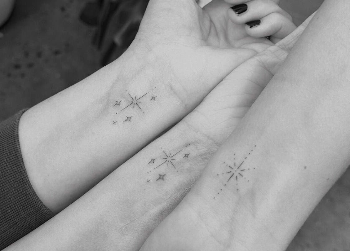 Minimalist star tattoos on wrists at Tri Line Tattoos in Auckland, Auckland, NZ. Elegant and detailed designs.
