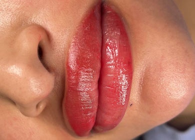 Glossy red lips enhanced at Anora Beauty Studio, Riyadh, Riyadh Province, SA.