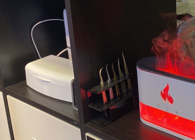 Anora Beauty Studio, Riyadh, showcases beauty tools and a glowing diffuser on a sleek shelf.