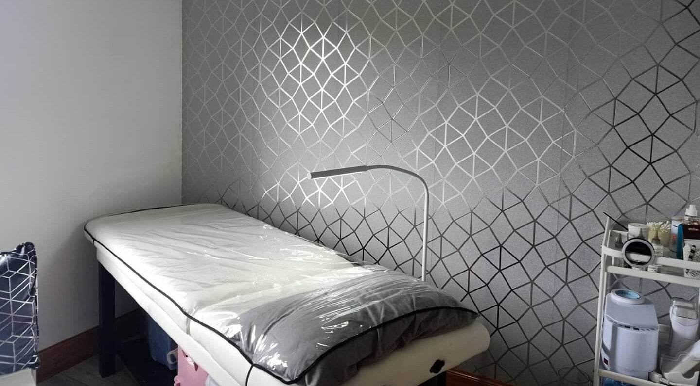 Modern treatment bed at Fìor Beauty Oban, Oban, Scotland, GB with geometric wall design.