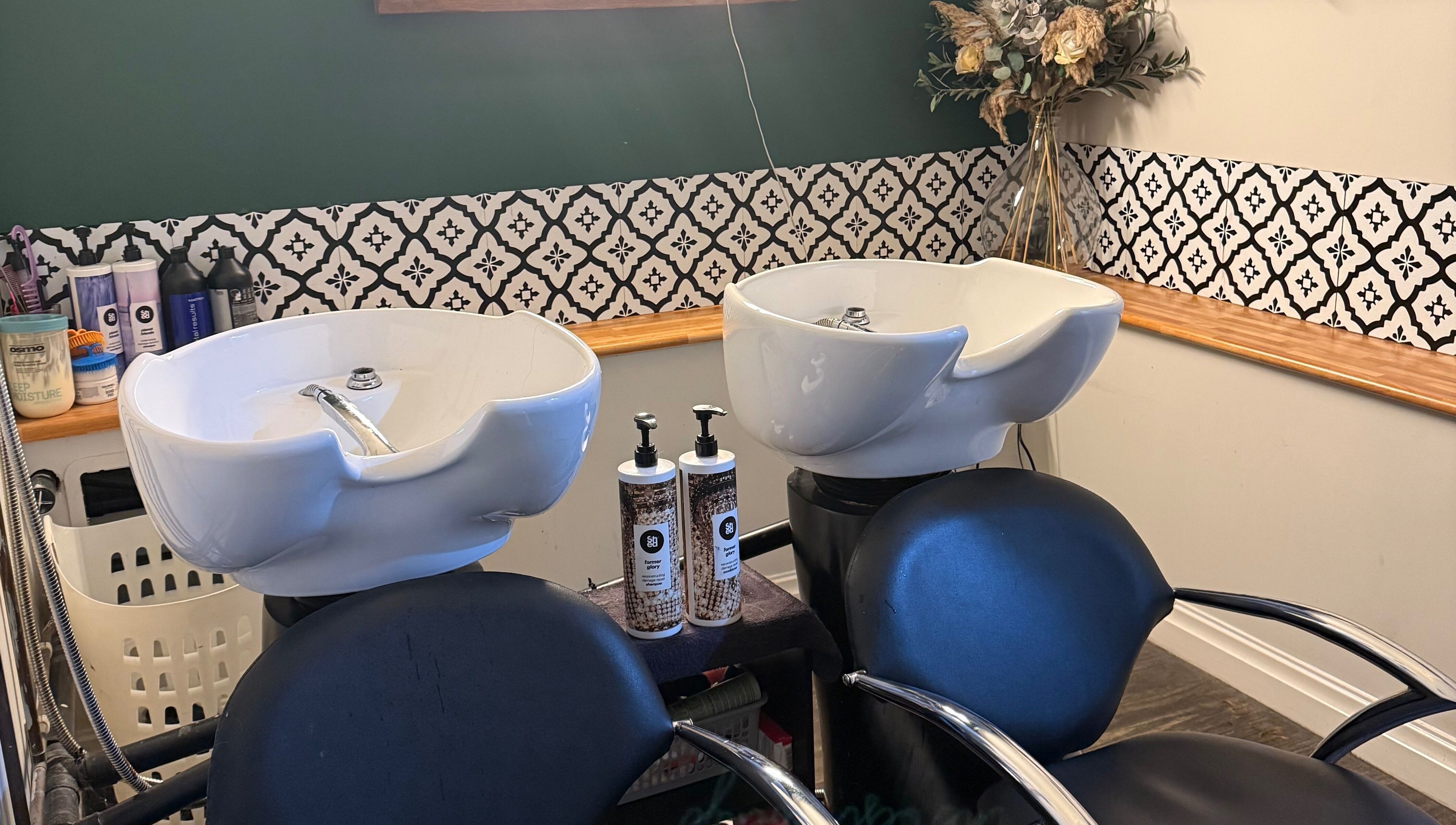 Elegant wash station at Kendrick and Whyatt Hair Studio, Glossop, England, GB, showcasing premium hair care products.