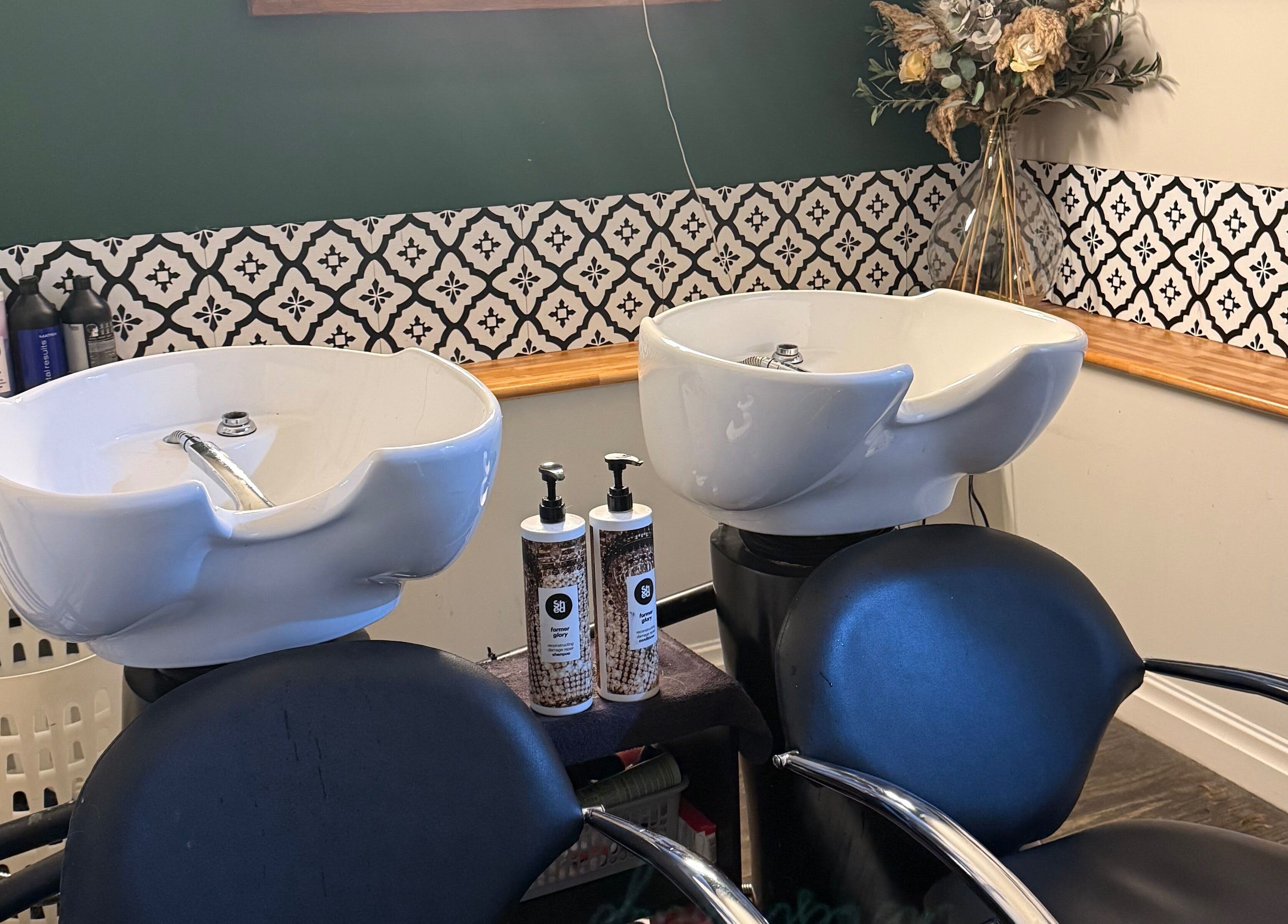 Elegant wash station at Kendrick and Whyatt Hair Studio, Glossop, England, GB, showcasing premium hair care products.