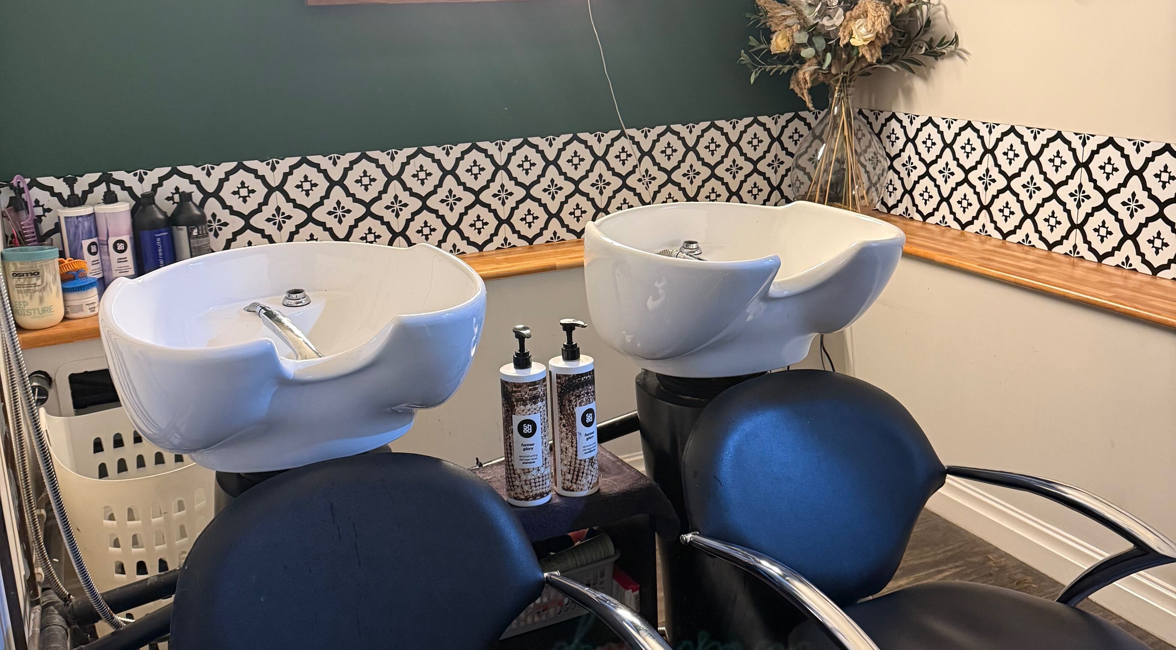 Elegant wash station at Kendrick and Whyatt Hair Studio, Glossop, England, GB, showcasing premium hair care products.
