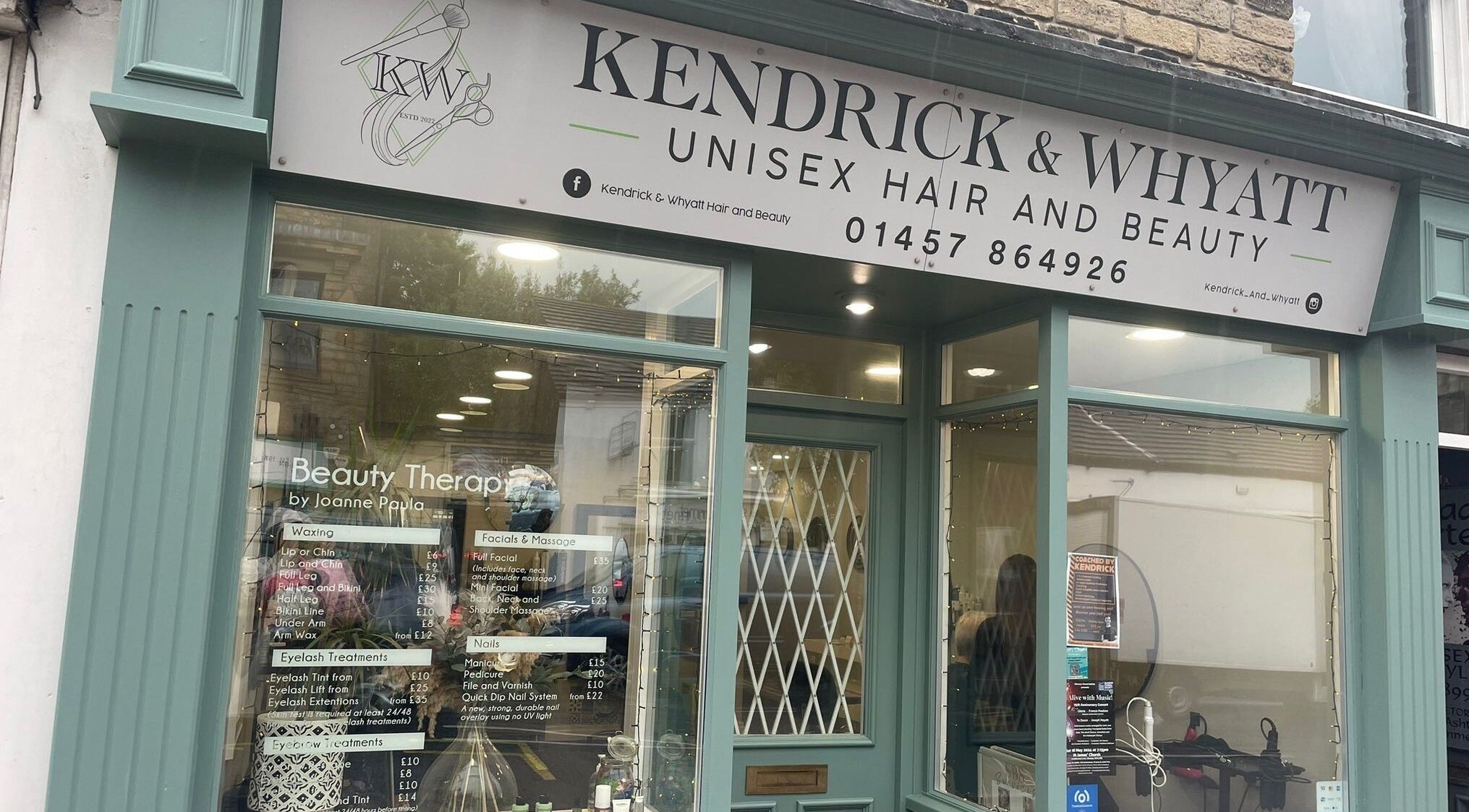 Front view of Kendrick and Whyatt Hair Studio in Glossop, England, showcasing elegant decor and welcoming entrance.
